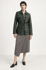 Woman wearing the Sofia forest green leather jacket, full-body front view