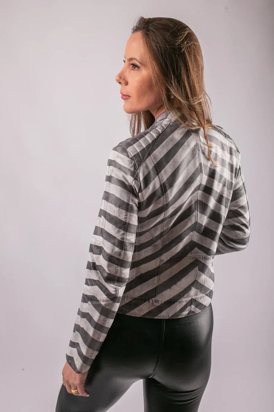 Back view of Nairobi grey and white stripe leather jacket on model, diagonal chevron pattern
