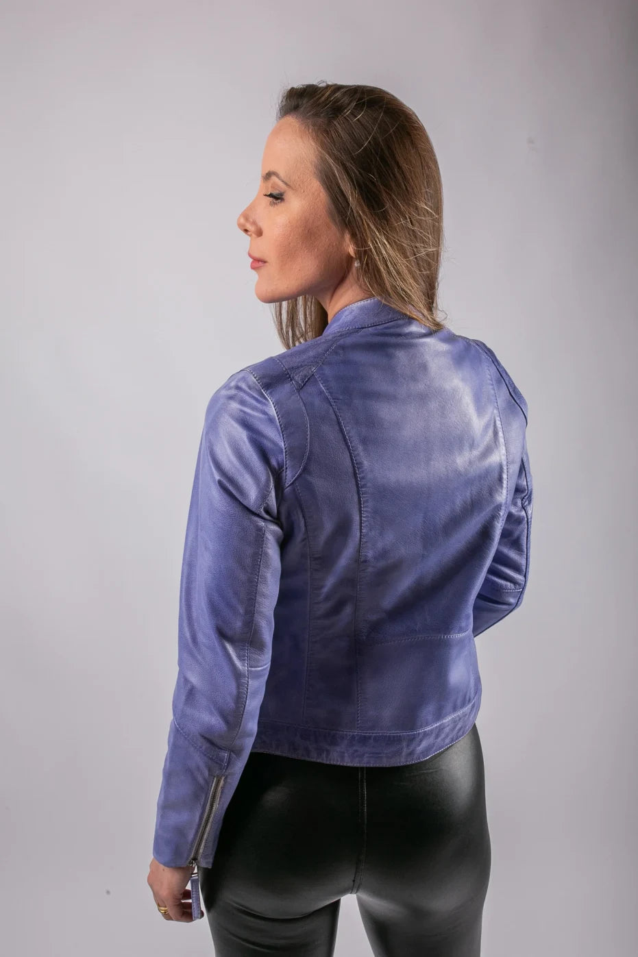 Back view of Milan lavender blue leather jacket on model, studio shot showing clean panel stitching