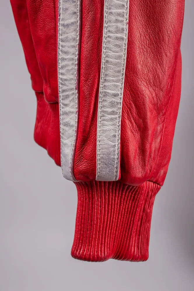 Roma red leather jacket extreme close-up of ribbed cuff and silver stripe, genuine leather texture