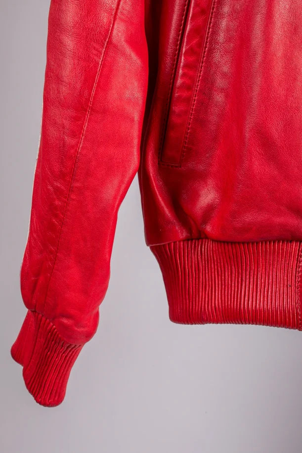 Roma red leather bomber jacket close-up side hem and ribbed cuff detail, clean leather grain texture