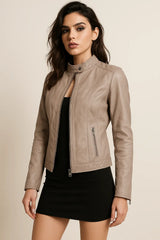 Woman wearing a cream lucca leather jacket on a beige background