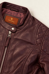 Close-up of the Bursa burgundy leather jacket with quilted shoulders and silver zippers