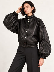 Woman wearing the Electra black leather jacket with puff sleeves, second alternate three-quarter view