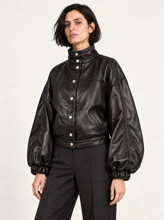 Woman wearing the Electra black leather jacket with puff sleeves, alternate three-quarter view