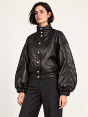 Woman wearing the Electra black leather jacket with puff sleeves, alternate three-quarter view