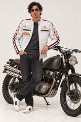 Man wearing the Tifrano MB dirty white leather jacket and sunglasses, standing next to a vintage motorcycle