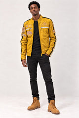 Man wearing the Tifrano MB yellow leather jacket, full-body front view with dark jeans and tan boots