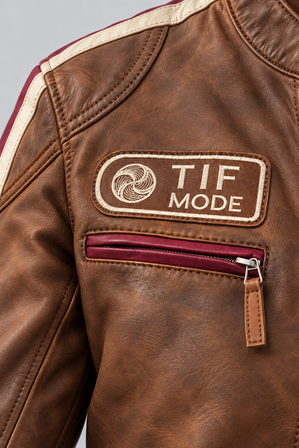 Close-up detail of the antique brown leather biker jacket
