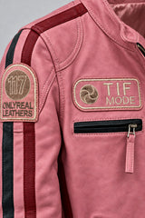 Close-up detail of the pink leather biker jacket with patches
