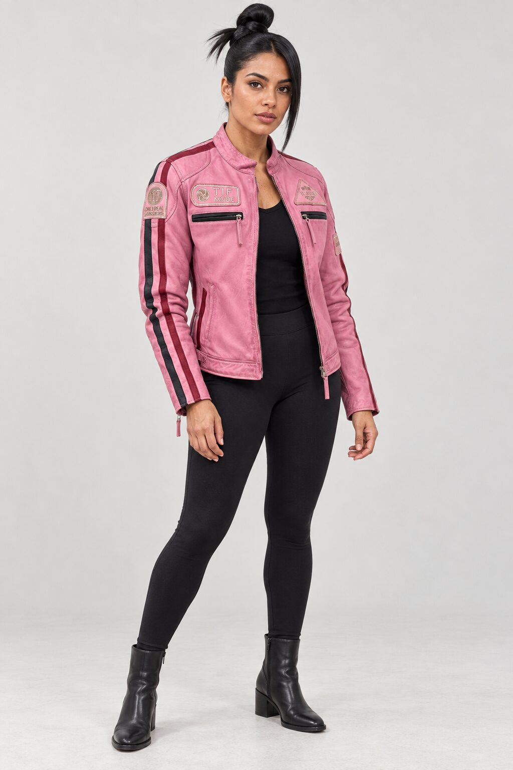 Woman wearing the pink leather biker jacket with patches, full-body front view