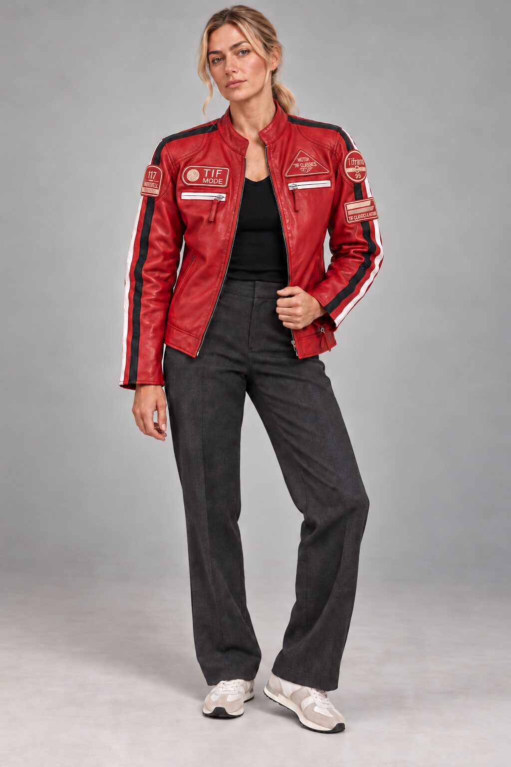 Woman wearing the red leather biker jacket with patches, full-body front view