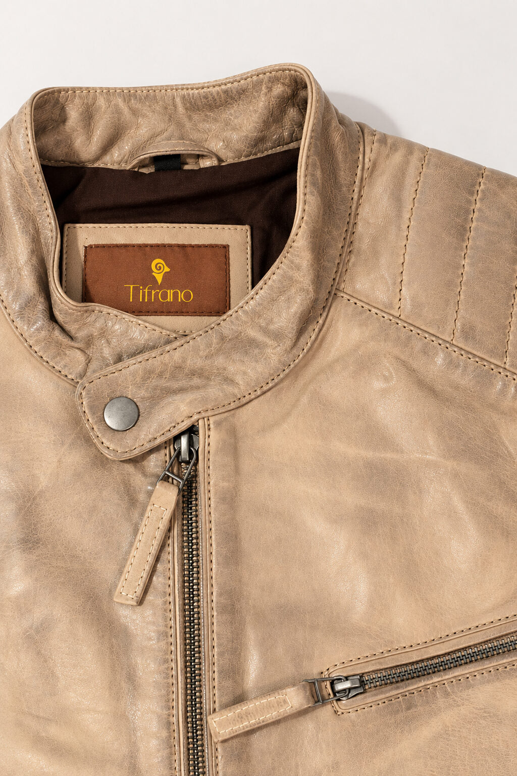 Close-up of the Toledo beige leather jacket with quilted panels, stand collar and zippers
