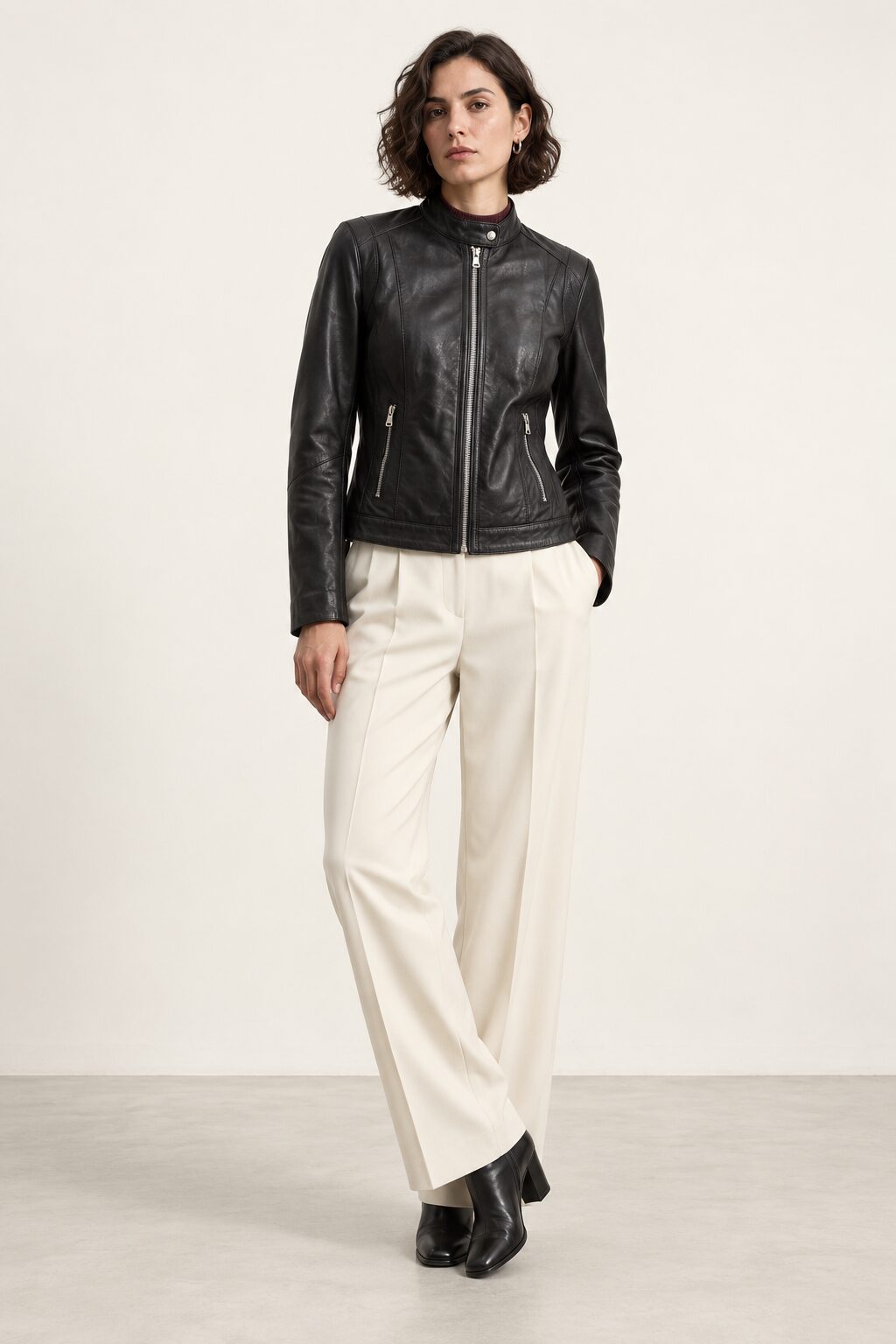 Woman wearing the Verona black leather jacket, full-body front view