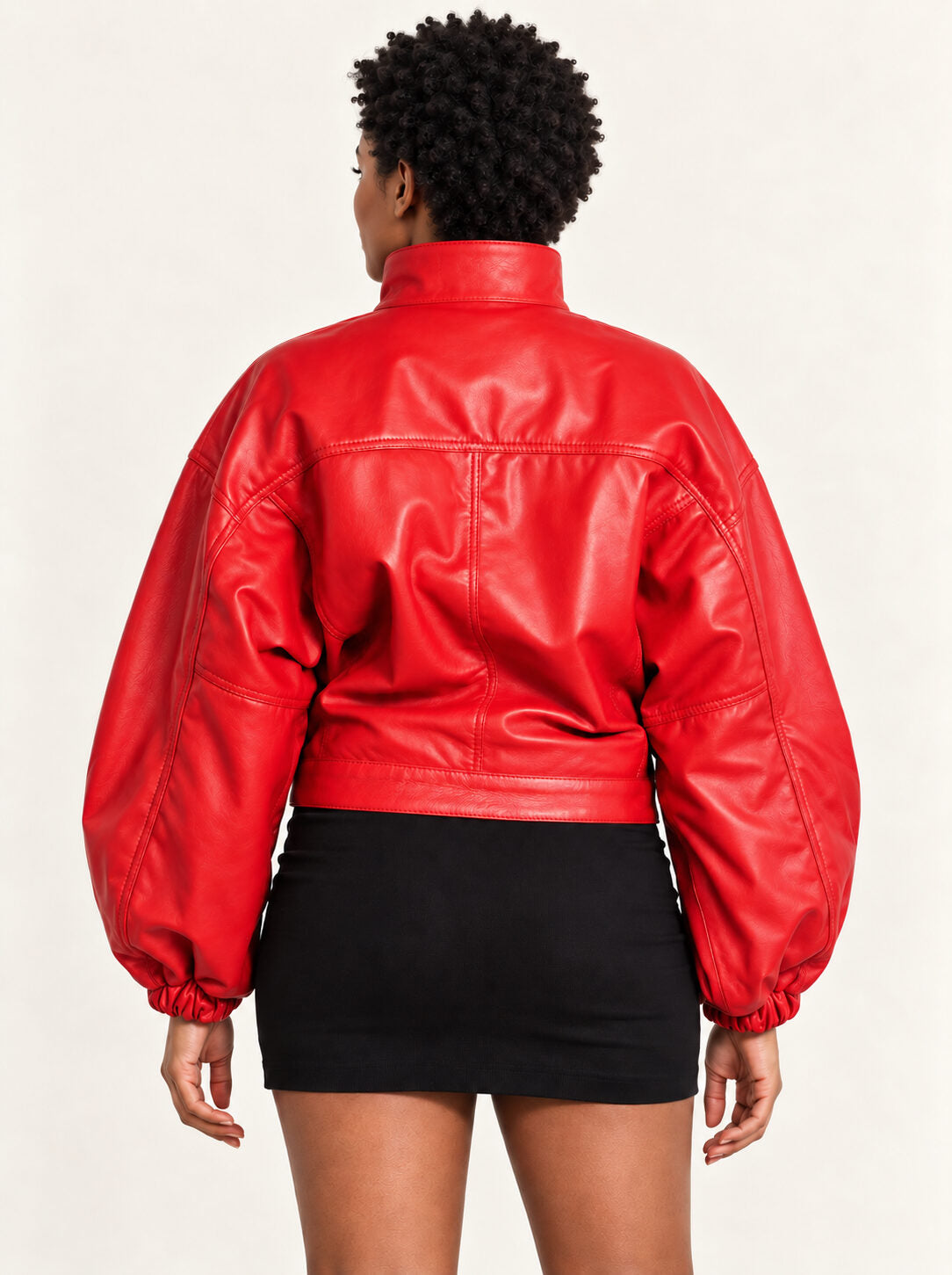 Close-up detail of the Vulkan red leather jacket with puff sleeves