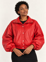 Woman wearing the Vulkan red leather jacket with puff sleeves, second alternate three-quarter view
