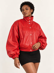 Woman wearing the Vulkan red leather jacket with puff sleeves, alternate three-quarter view