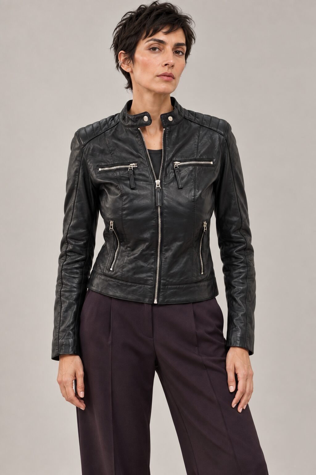 Woman wearing the Buenos Aires black leather jacket with quilted shoulders and zip pockets, front view