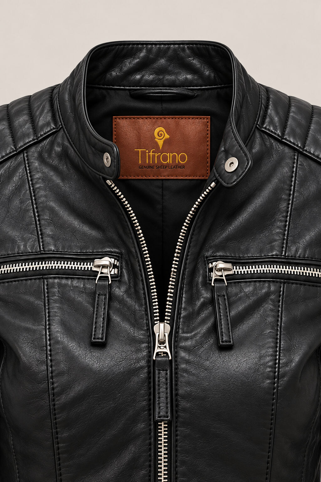 Close-up of the Buenos Aires black leather jacket, showing stand collar, quilted shoulders, silver zippers and leather texture