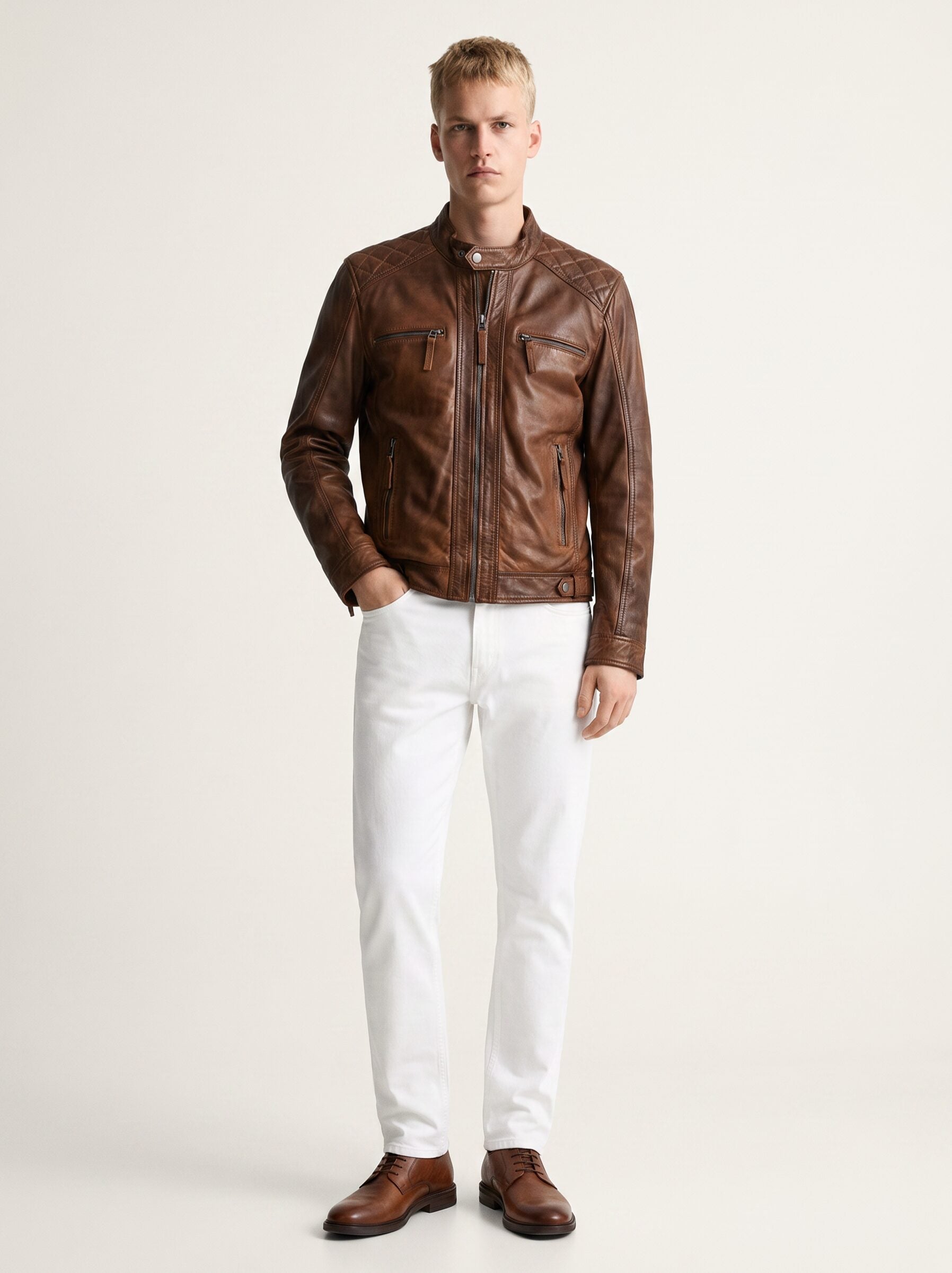 Man wearing the Brujas cognac leather racer jacket, full-body front view