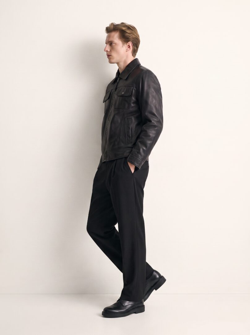 Man wearing the Budapest black leather trucker jacket, three-quarter view