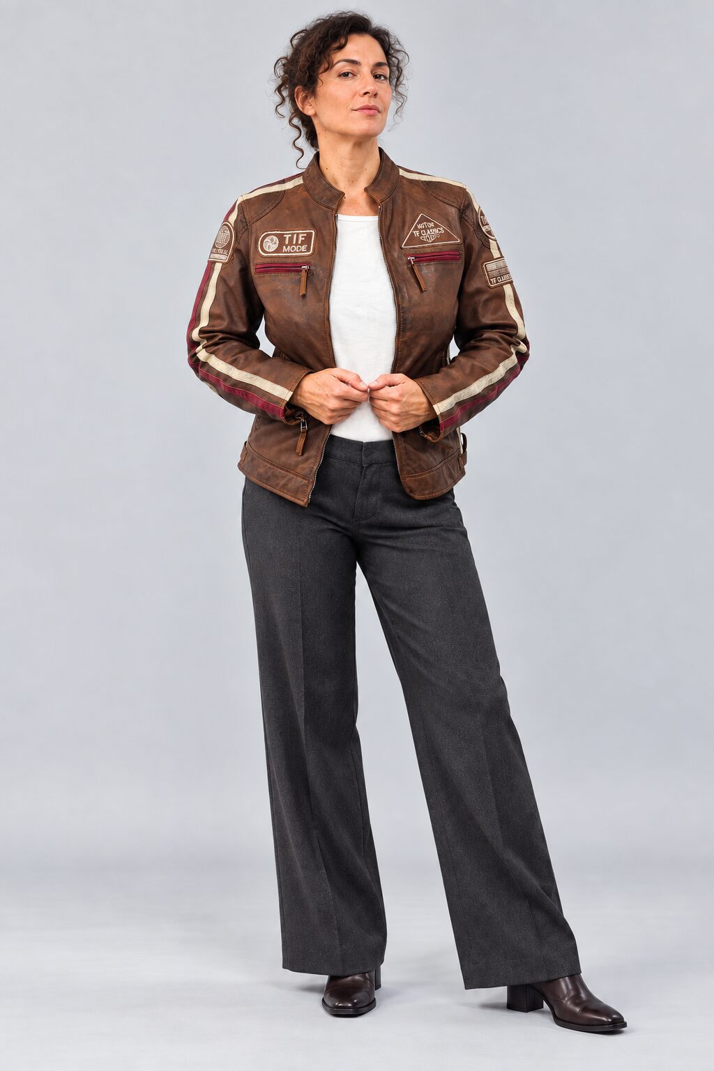 Woman wearing the antique brown leather biker jacket, full-body front view