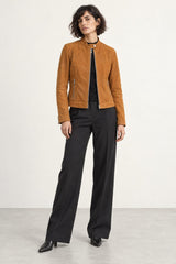 Woman wearing the Minerva camel suede jacket, three-quarter view