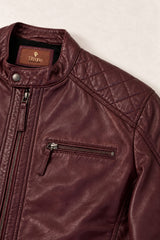 Close-up of the Tifrano Prague burgundy leather jacket showing the quilted shoulder, snap collar, chest zip and leather texture.