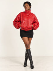 Woman wearing the Vulkan red leather jacket with puff sleeves, full-body front view