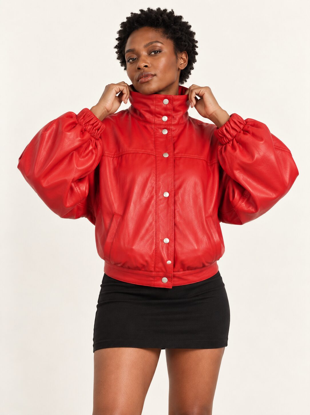 Woman wearing the Vulkan red leather jacket with puff sleeves, three-quarter view