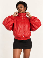 Woman wearing the Vulkan red leather jacket with puff sleeves, three-quarter view